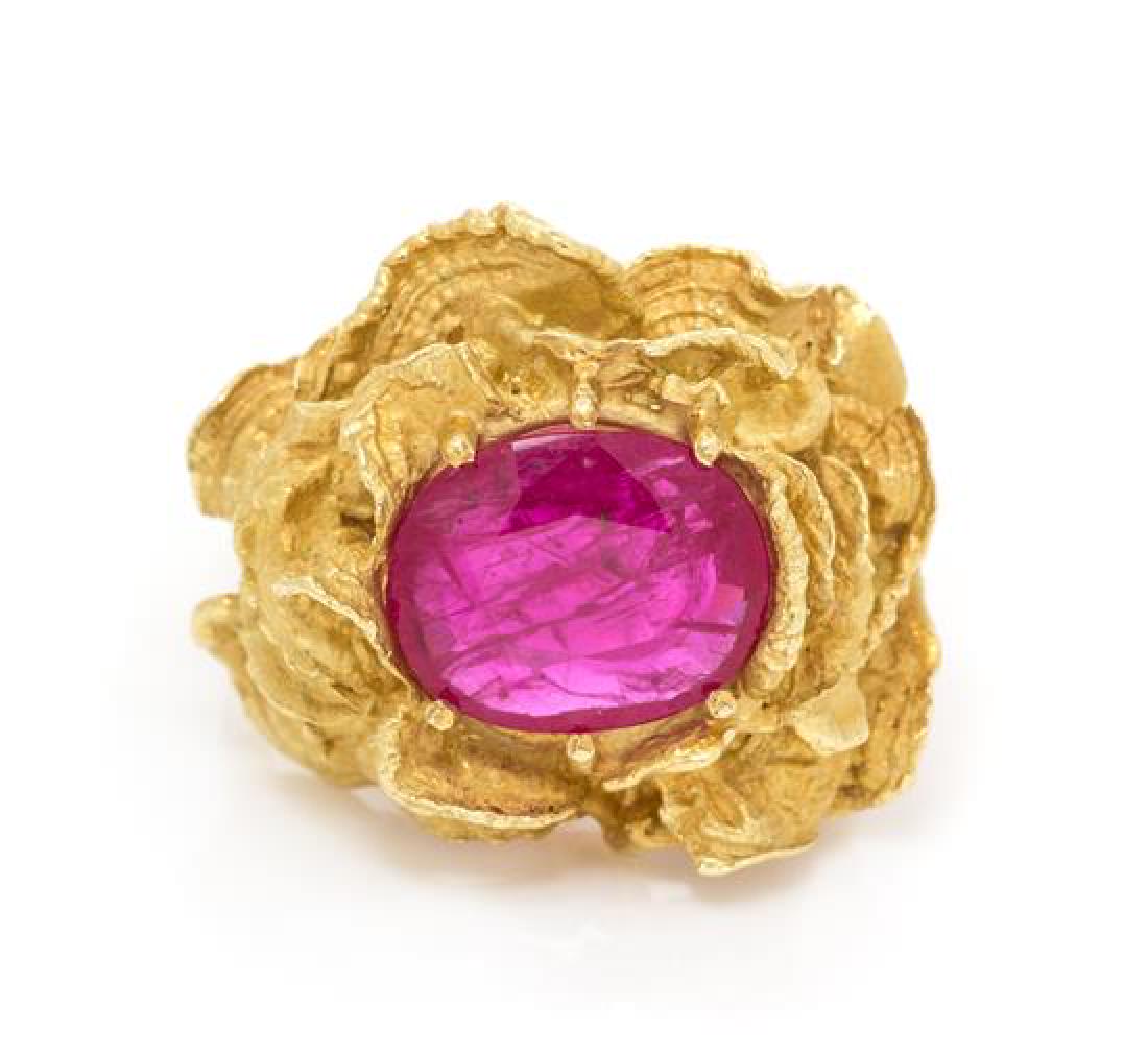 An 18 Karat Yellow Gold and Ruby Ring, 8.10 dwts.: An 18 Karat Yellow Gold and Ruby Ring, containing one oval mixed cut ruby measuring approximately 11.70 x 9.25 x 2.95 mm within a gold free form design. Stamp: 18K. 8.10 dwts. Estimate $1,200-1,800 Th