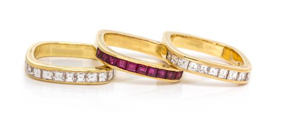 A Collection of 18 Karat Yellow Gold, Diamond and Ruby: A Collection of 18 Karat Yellow Gold, Diamond and Ruby Stacking Rings, David Morris, Circa 1985, consisting of one ring containing 11 square step cut diamonds weighing approximately 1.10 carats total,