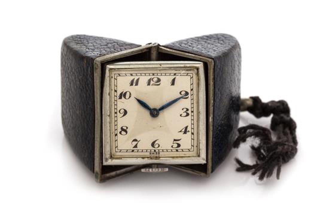 A Metal and Leather Pocket Watch Travel Clock, Henry: A Metal and Leather Pocket Watch Travel Clock, Henry Turnheim for Rautte, central hinged leather covered case measuring approximately 44.00 x 28.00 x 15.00 mm closed, matte silvered dial, Roman numera