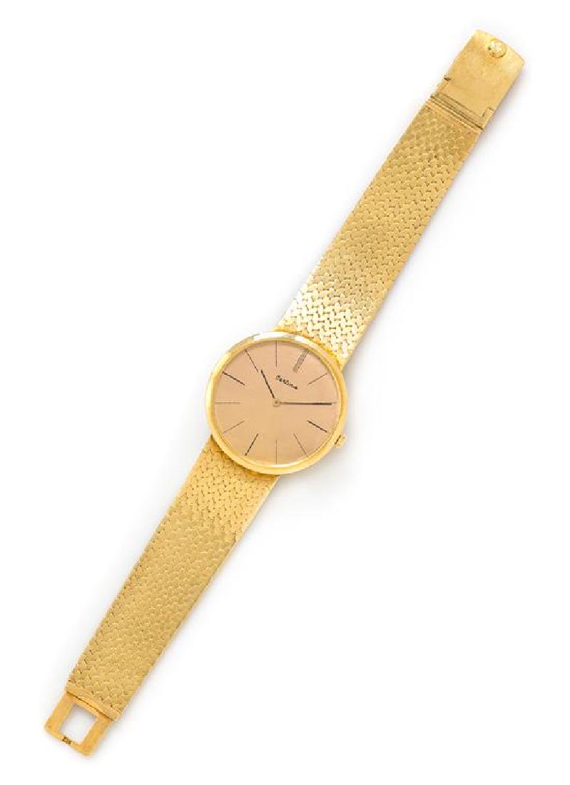 * An 18 Karat Yellow Gold Wristwatch, Certina, 44.45: * An 18 Karat Yellow Gold Wristwatch, Certina, 32.00 mm case diameter, champagne dial signed Certina, black baton numerals, black pencil hands, snap on case back, Cal. 20-10 manual wind 17 jewel movem