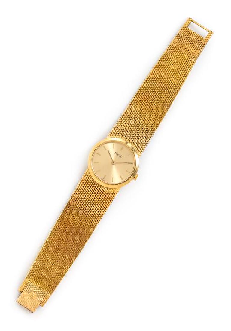 An 18 Karat Yellow Gold Wristwatch, Piaget, 29.10 dwts.: An 18 Karat Yellow Gold Wristwatch, Piaget, 24.00 mm case diameter, matte gold dial signed PIAGET, applied gold baton numerals, gold pencil hands, case back affixed with two screws, coin edge crown, C
