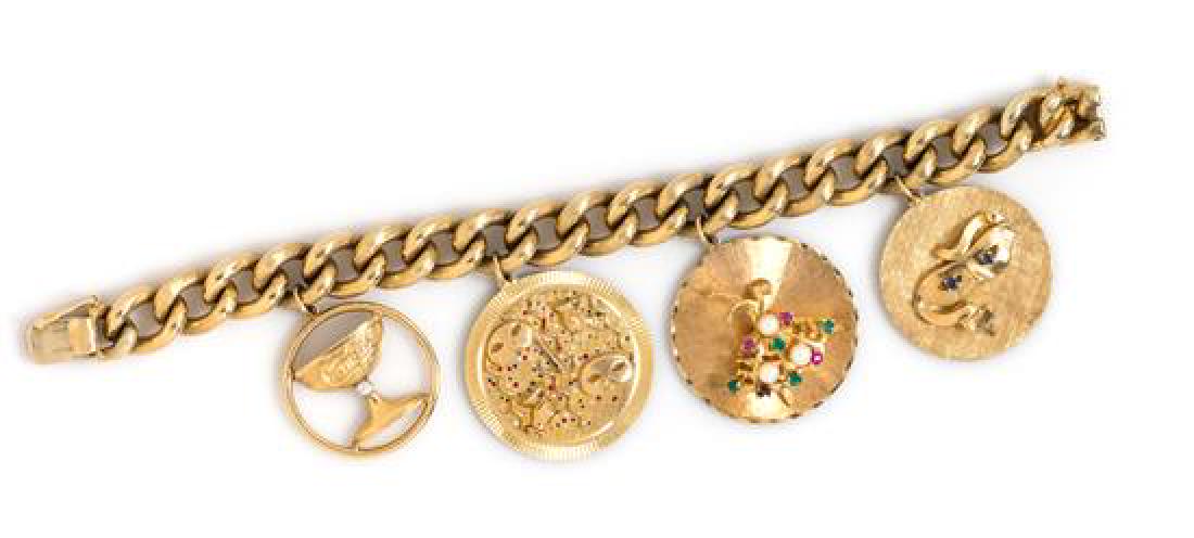 A 14 Karat Yellow Gold Bracelet with Four Attached: A 14 Karat Yellow Gold Bracelet with Four Attached Charms, Zelman & Friedman, including a 14 karat gold 'Comus' chalice disc charm containing one round brilliant cut diamond, a 14 karat gold carnival 