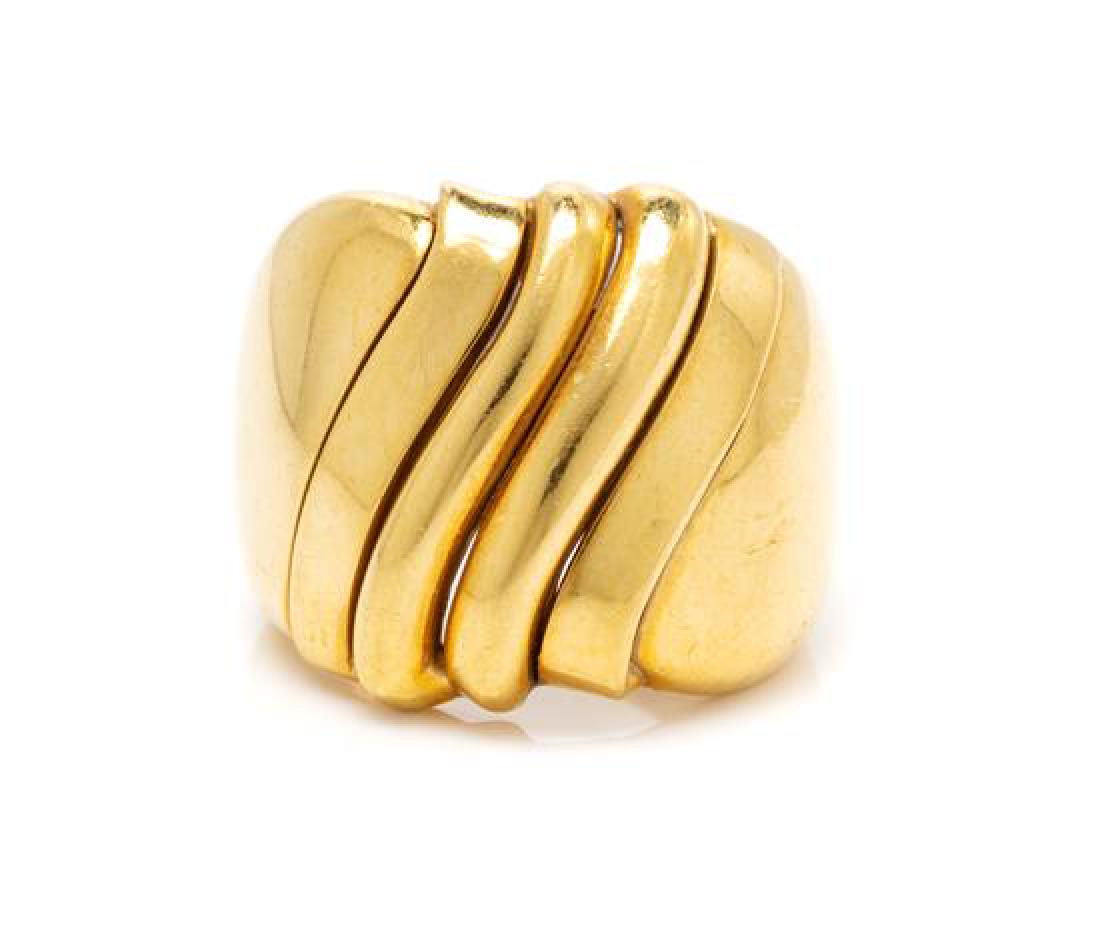 An 18 Karat Yellow Gold Ring, Italian, 8.15 dwts.: An 18 Karat Yellow Gold Ring, Italian, consisting of a tapered band with central curving lines. Stamp: 750 ITALY OE. 8.15 dwts. Estimate $200-400 The ring is an approximate size 6 1/4 on the mandrel.