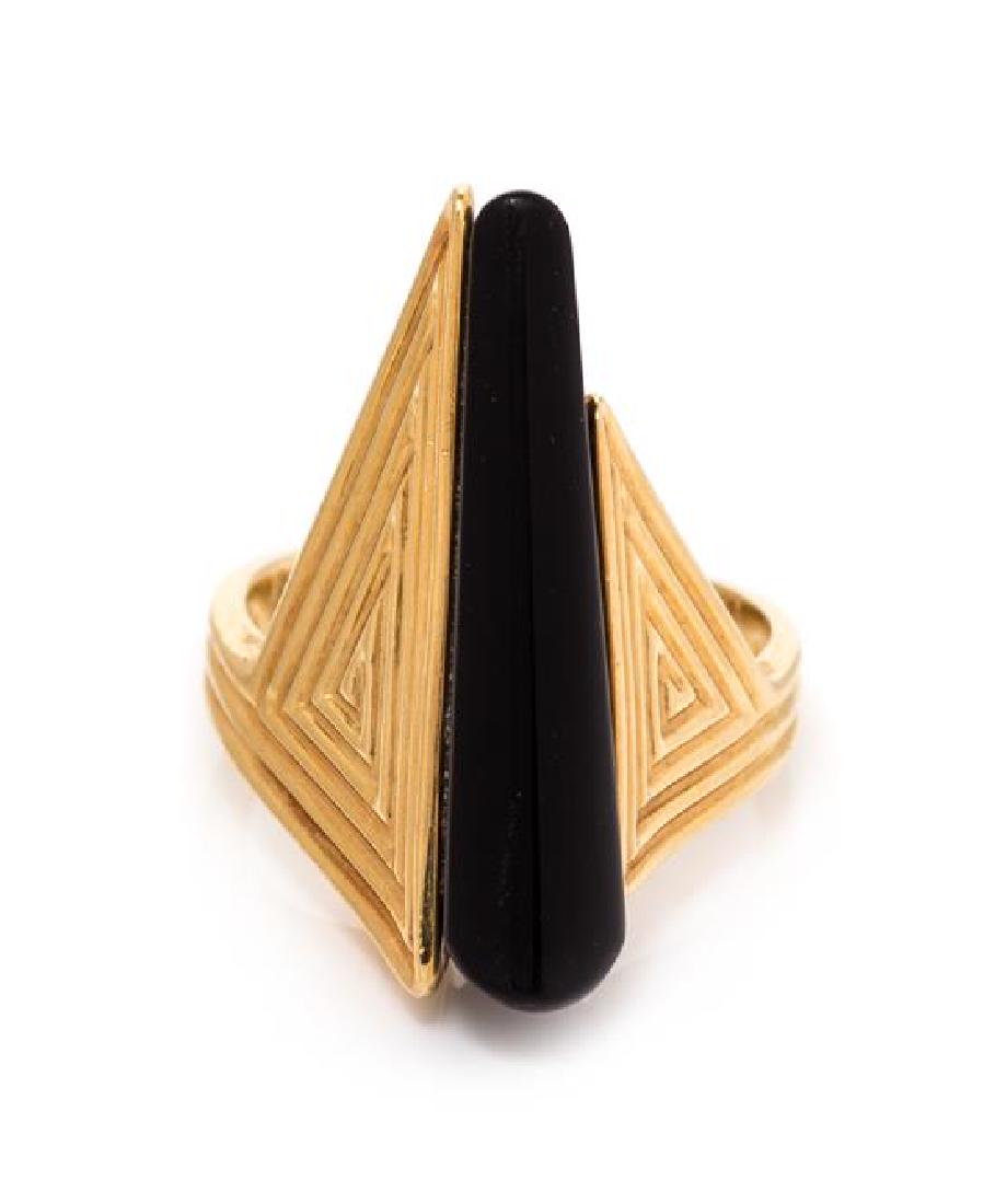 * An 18 Karat Yellow Gold and Onyx Ring, Erte, 6.10: * An 18 Karat Yellow Gold and Onyx Ring, Erte, containing an elongated onyx wedge shape plaque measuring approximately 25.00 x 5.98-3.41 mm. Stamp: CFA 18K 3/500. 6.10 dwts. Estimate $250-350 Property