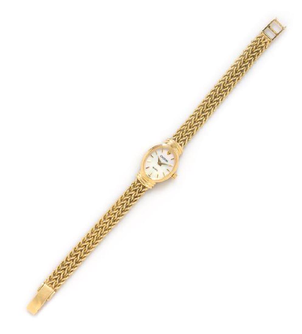 *A 14 Karat Yellow Gold Wristwatch, Croton, 12.40 dwts.: *A 14 Karat Yellow Gold Wristwatch, Croton, 17.00 x 21.00 mm case applied gold baton numerals, gold pitched dauphine hands, oval case, stepped lugs, snap on case back, quartz movement, integrated four