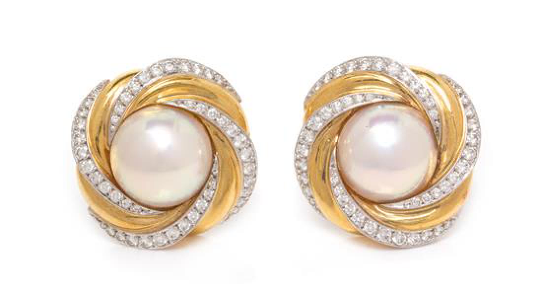 A Pair of 18 Karat Yellow Gold, Cultured Mabe Pearl and: A Pair of 18 Karat Yellow Gold, Cultured Mabe Pearl and Diamond Earclips, Mikimoto, containing two mabe pearls measuring approximately 13.00 mm in diameter surrounded by numerous round brilliant cut d