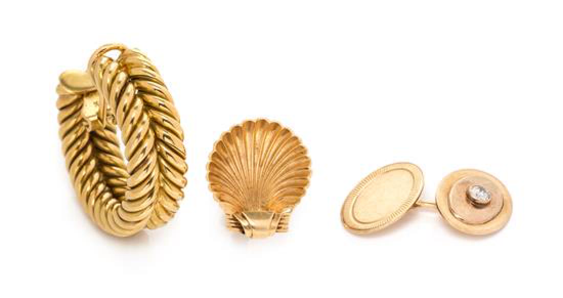 A Collection of Yellow Gold Jewelry, 11.25 dwts.: A Collection of Yellow Gold Jewelry, consisting of a single 18 karat gold twisted rib earclip, a single 14 karat gold screwback shell motif earclip, together with a single 14 karat gold cufflink conta