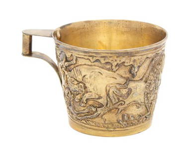 A Greek Chased Silver Gilt Cup, Ilias Lalaounis, 20th: A Greek Chased Silver Gilt Cup Ilias Lalaounis, 20th Century after the design of the Vaphoio cups with repousse decoration of buccolic scenes marked 900 6 ozt 2 dwt Height 3 1/4 x diameter 4 inches. E