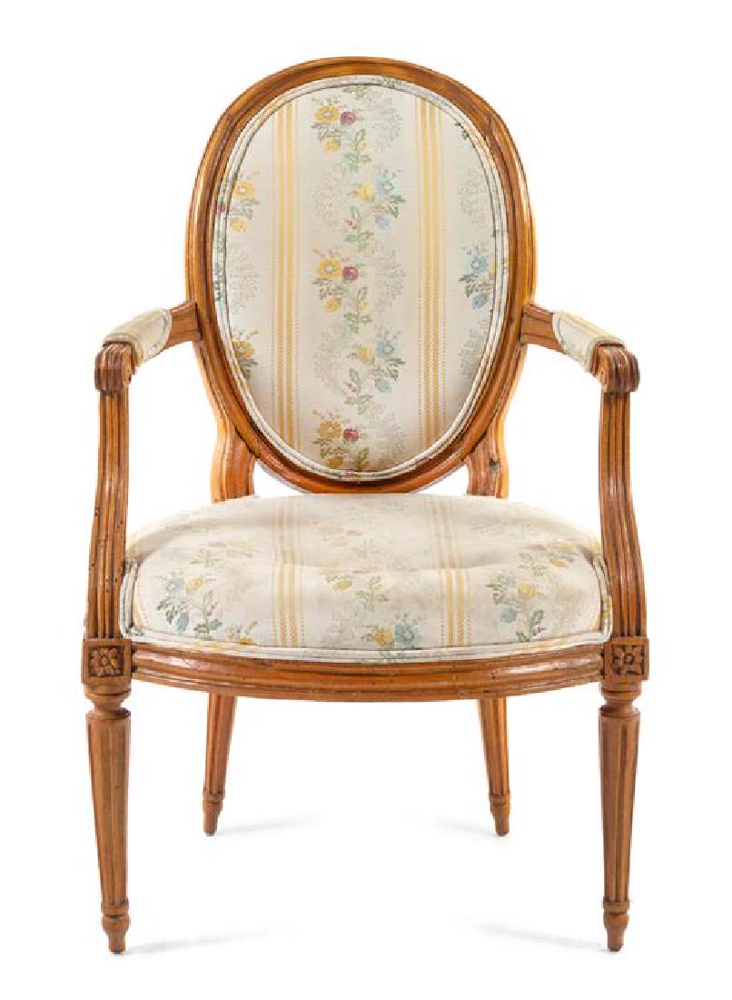 * A Louis XVI Beech Fauteuil Height 36 inches.: * A Louis XVI Beech Fauteuil 18th century the oval padded back, arms and stuffover seat raised on cylindrical fluted tapering legs. Height 36 inches. Estimate $400-600 Property from the Collection of 