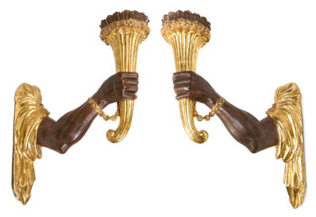 A Pair of Continental Painted and Parcel Gilt Sconces: A Pair of Continental Painted and Parcel Gilt Sconces 20th century each in the form of a robed arm supporting a cornucopia. Height 25 inches. Estimate $1,500-2,500 Each in stable condition, with candl