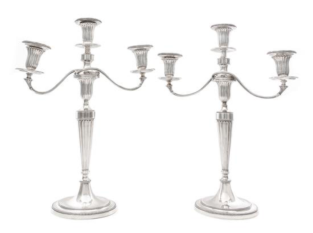 A Pair of George III Silver Three-Light Candelabra,: A Pair of George III Silver Three-Light Candelabra John Schofield, London, 1781; the Branches Marked for 1796 each fluted tapering stem issuing the scrolling arms and urn form candle cups, raised on a