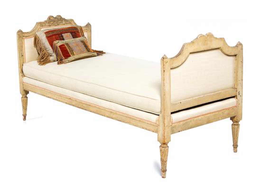 A Louis XVI Style Painted Daybed Height 31 1/2 x width: A Louis XVI Style Painted Daybed circa 1900 the rectangular cushion seat flanked by two padded sides, raised on cylindrical fluted tapering legs. Height 31 1/2 x width 65 x depth 27 inches. Estimate $