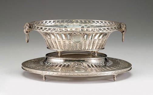 English sterling silver centerpiece on stand, char: English sterling silver centerpiece on stand charles & richard comyns, london 1925 Of oval form with a pierced Vitruvian scroll rim above ribbon-tied medallions, with flanking ram's mask handles raise