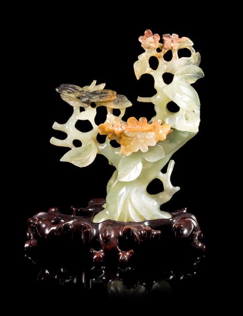 * A Serpentine Carving of a Flowering Tree Height 6 1/4: * A Serpentine Carving of a Flowering Tree 20th century of naturalistic form, raised on a fitted hardwood stand. Height 6 1/4 inches. Estimate $400-600 Property from the Estate of Philip and Jean Lask