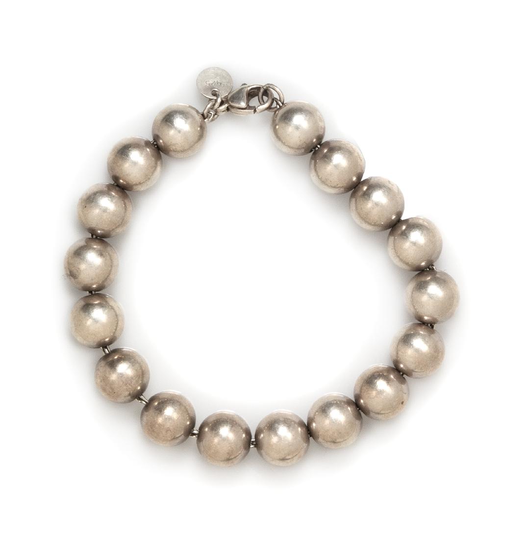 A Sterling Silver Bead Bracelet, Tiffany & Co., 12.15: A Sterling Silver Bead Bracelet, Tiffany & Co., consisting of round beads measuring approximately 10.00 mm in diameter, strung on chain with lobster clasp. Stamp: TIFFANY & Co. 925. 12.15 dwts. Estima