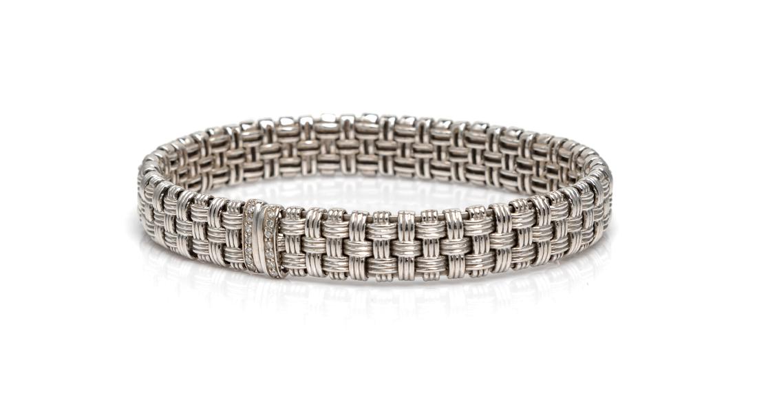 A White Gold and Diamond 'Appassionata' Bracelet,: A White Gold and Diamond 'Appassionata' Bracelet, Roberto Coin, consisting of a semi-flexible bracelet containing 14 round brilliant cut diamonds weighing approximately 0.07 carat total. 15.00 dwts. E