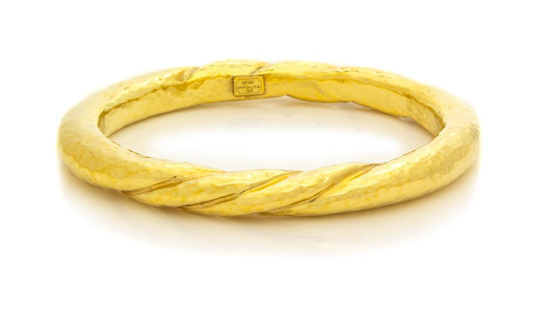 An 18 Karat Yellow Gold Bangle Bracelet, Ippolita, 8.70: An 18 Karat Yellow Gold Bangle Bracelet, Ippolita, with hammered gold texture, measuring approximately 7.75 mm wide. Stamp: IPPOLITA 18K. 8.70 dwts. Estimate $500-700
