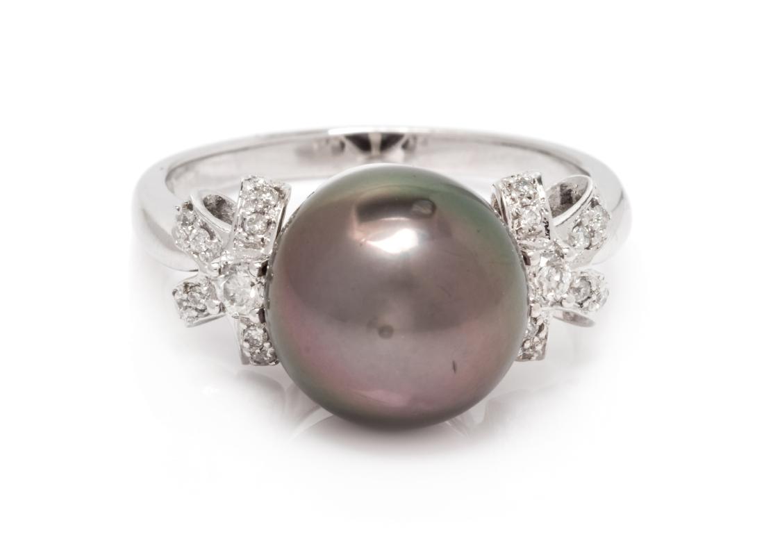 A 14 Karat White Gold, Cultured Tahitian Pearl and: A 14 Karat White Gold, Cultured Tahitian Pearl and Diamond Ring, containing one Tahitian pearl measuring approximately 11.40 mm in diameter and 18 round brilliant cut diamonds weighing approximately 0