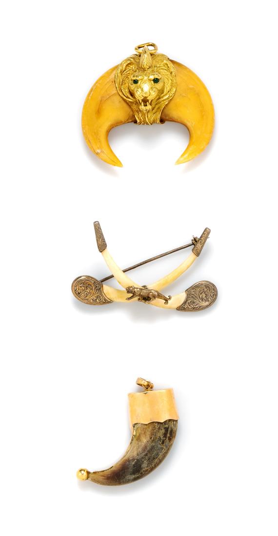 * A Collection of Animal Claw Jewelry, 42.45 dwts.: * A Collection of Animal Claw Jewelry, consisting of a yellow gold pendant containing one bear claw, a yellow gold lion head pendant containing two round cabochon cut emerald eyes measuring approximat