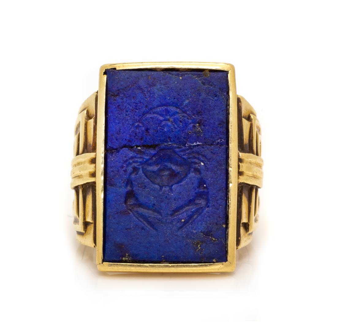 An Art Deco 14 Karat Yellow Gold and Lapis Lazuli: An Art Deco 14 Karat Yellow Gold and Lapis Lazuli Intaglio Ring, containing one rectangular lapis lazuli intalgio plaque measuring approximately 23.05 x 14.45 mm carved with the image of a crab. Stamp