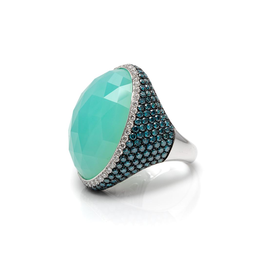 * An 18 Karat White Gold, Chalcedony, Diamond and: * An 18 Karat White Gold, Chalcedony, Diamond and Irradiated Colored Diamond Ring, Verdi, containing one oval shape rose cut chalcedony measuring approximately 29.00 x 22.05 mm, 47 round brilliant cut