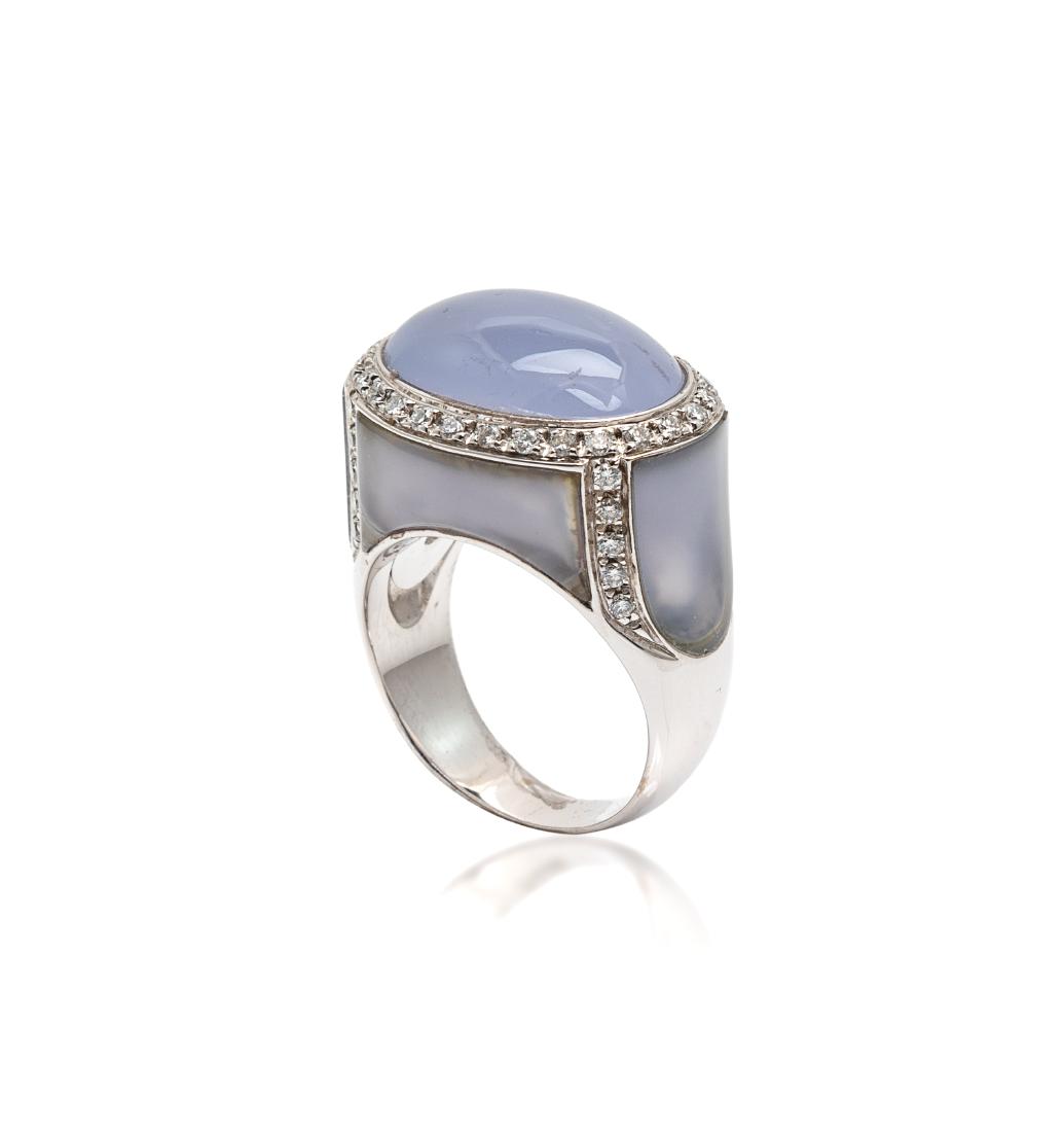 * A White Gold, Blue Chalcedony and Diamond Ring, 12.00: * A White Gold, Blue Chalcedony and Diamond Ring, containing one oval cabochon cut blue chalcedony measuring approximately 18.35 x 12.87 mm, four blue chalcedony inlay sections and 46 round brilliant