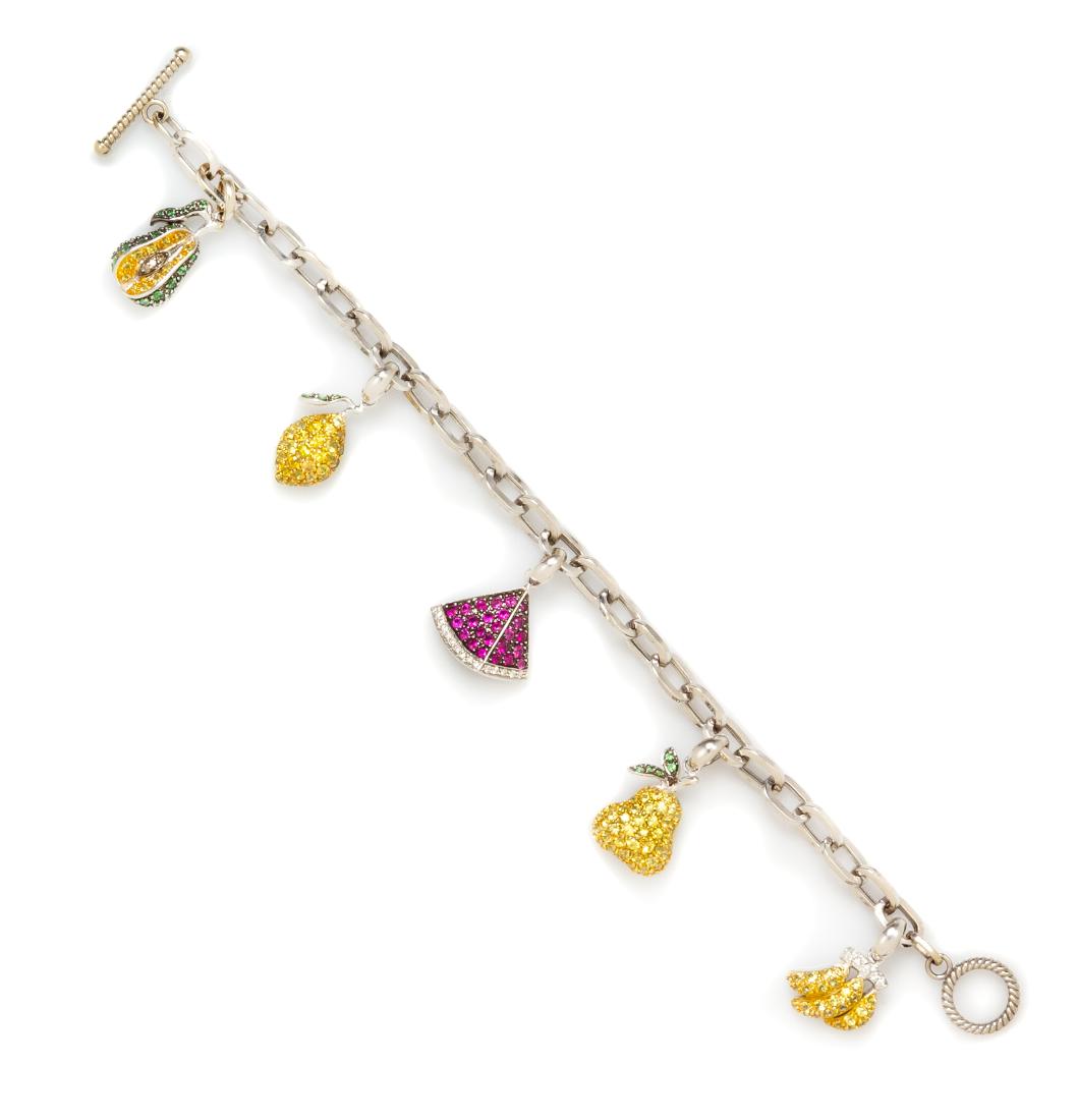 An 18 Karat White Gold, Multigem and Diamond Fruit: An 18 Karat White Gold, Multigem and Diamond Fruit Motif Charm Bracelet, consisting of a cable link bracelet suspending five white gold charms including a pear, lemon, watermelon slice, and bananas co