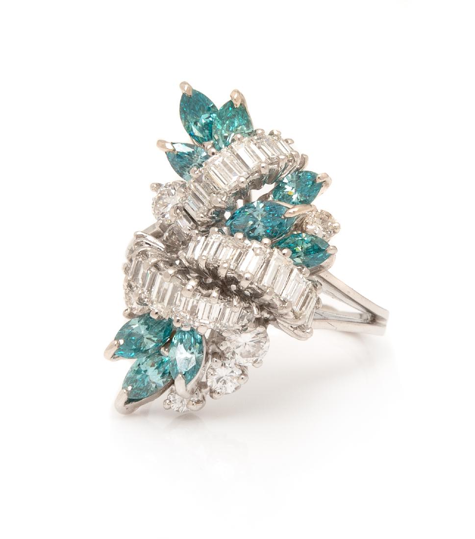 An 18 Karat White Gold, Diamond and Colored Diamond: An 18 Karat White Gold, Diamond and Colored Diamond Ring, containing six round brilliant cut diamonds weighing approximately 0.51 carat total, 26 baguette cut diamonds weighing approximately 1.05 cara