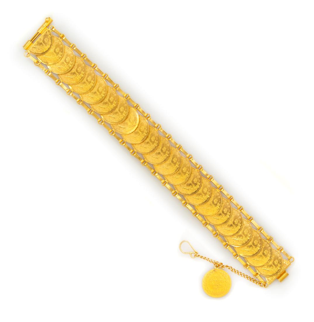 A High Karat Yellow Gold and Ottoman 100 Kurush Coin: A High Karat Yellow Gold and Ottoman 100 Kurush Coin Bracelet, containing 24 early 20th century Ottoman Empire 100 Kurush gold coins overlapping within two flexible link chains, sliding pin clasp with