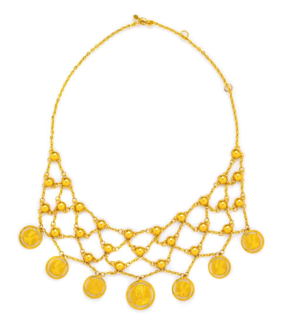 * An 18 Karat Gold Necklace, 23.20 dwts.: * A Yellow Gold and Coin Bib Necklace, consisting of chain and half round links suspending seven "coin" pendants, with toggle clasp. Stamp: Arabic hallmark. 23.20 dwts. Estimate $1,000-1,500 Property 