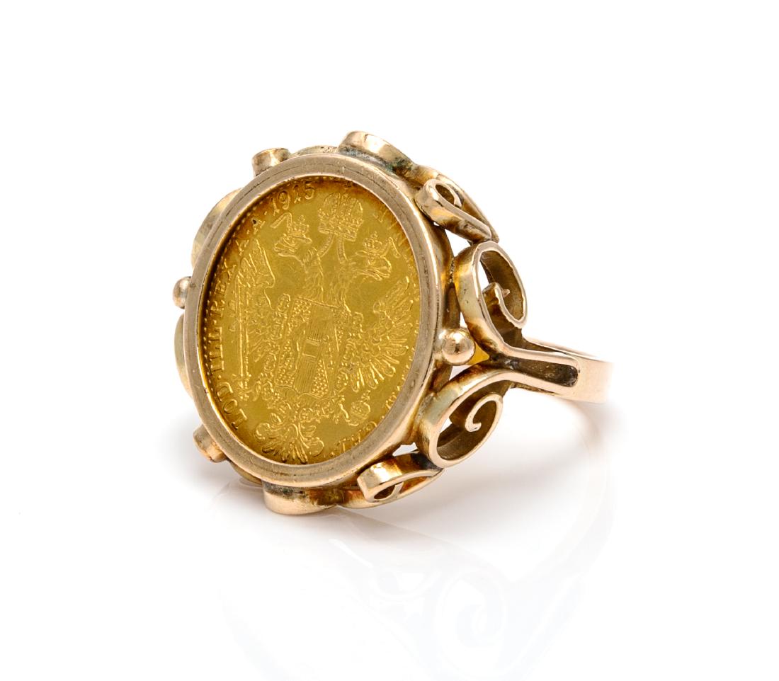 * A 14 Karat Yellow Gold and Austrian 1 Ducat 1915: * A 14 Karat Yellow Gold and Austrian 1 Ducat 1915 Restrike Gold Coin Ring, containing one Austrian 1 Ducat restrike gold coin, 1915 gold coin within a curvilinear mounting. Stamp: 14K. 7.40 dwts. Est