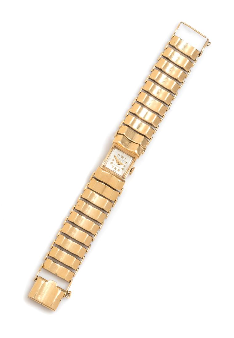 A 14 Karat Yellow Gold Wristwatch, Etna Watch Co.,: A 14 Karat Yellow Gold Wristwatch, Etna Watch Co., 14.00 x 19.00 mm case dimensions, matte silver dial signed Etna Watch Co., applied Arabic numerals, gold dauphine hands, snap on case back, later qua