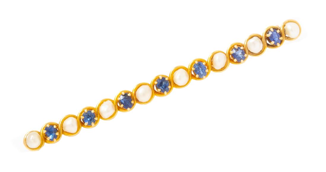 An Antique Yellow Gold Sapphire and Baroque Pearl Bar: An Antique Yellow Gold Sapphire and Baroque Pearl Bar Brooch, containing seven mixed cut sapphires measuring approximately 4.00 x 2.75 mm and eight baroque pearls (origin not tested) measuring approxi