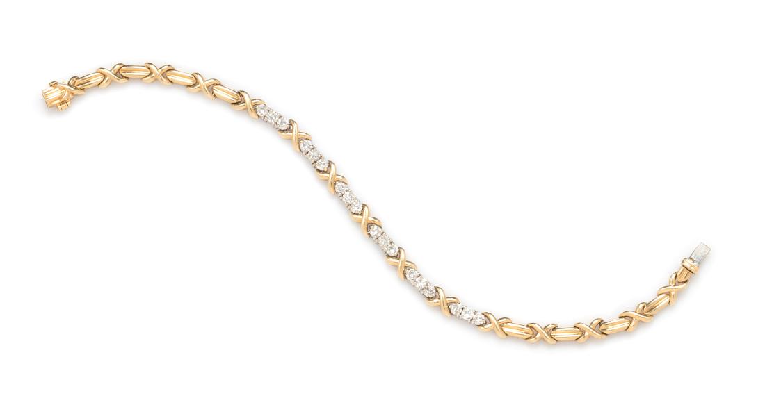 * A 14 Karat Yellow Gold and Diamond Bracelet, 5.80: * A 14 Karat Yellow Gold and Diamond Bracelet, containing 18 round brilliant cut diamonds weighing approximately 0.90 carat total. Stamp: 585 (maker's mark). 5.80 dwts. Estimate $300-500 Property from