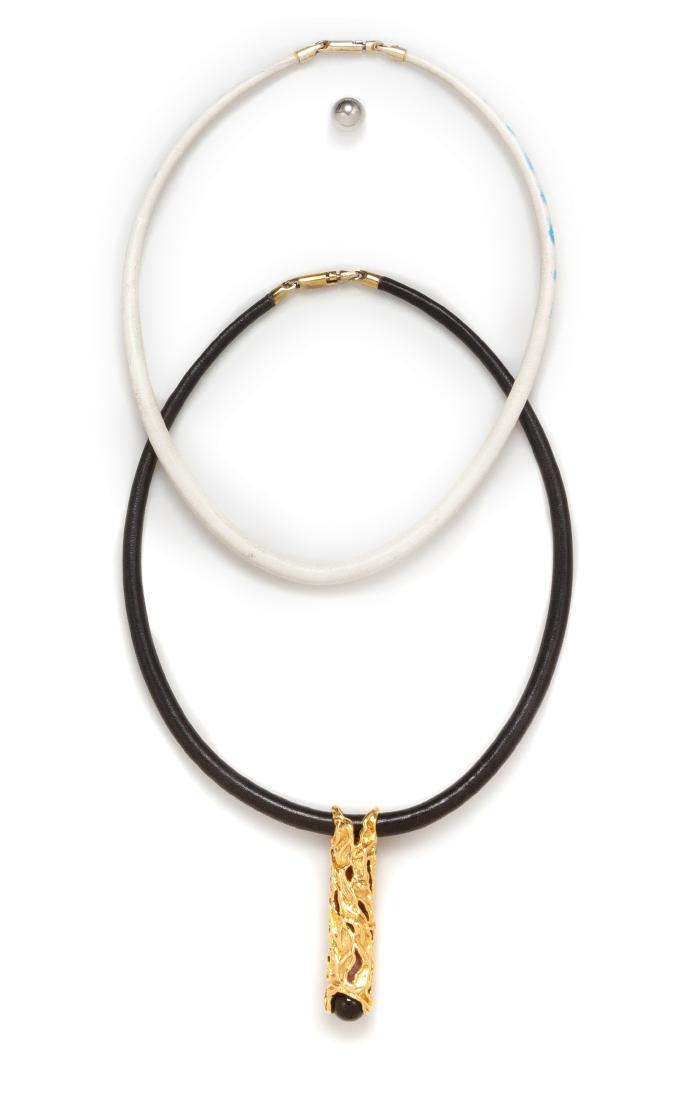 An 18 Karat Yellow Gold, Sterling Silver, Hardstone and: An 18 Karat Yellow Gold, Sterling Silver, Hardstone and Leather Pendant/Necklace, consisting of an 18 karat yellow gold free form tubular pendant containing interchangeable onyx, malachite, amber, rho