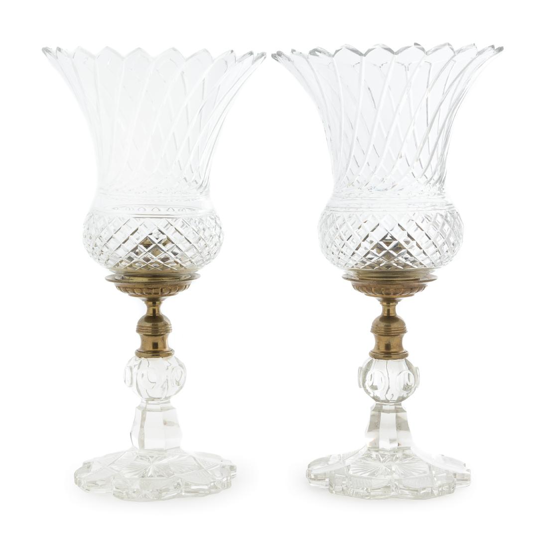 A Pair of Cut Glass Hurricane Candlesticks Height 16: A Pair of Cut Glass Hurricane Candlesticks 19th century the thistle form shades with geometric decoration, raised on a knopped stem ending in a shaped circular foot. Height 16 3/4 inches. Estimate $80