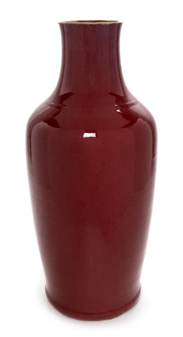 A Chinese Sang-de-Boeuf Glazed Porcelain Vase Height 21: A Chinese Sang-de-Boeuf Glazed Porcelain Vase 19th century of baluster form, surmounted by a tall cylindrical neck. Height 21 1/2 inches. Estimate $300-500 Height 54.6cm