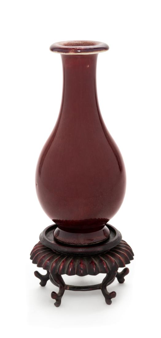* A Chinese Sang-de-Boeuf Glazed Porcelain Vase Height: * A Chinese Sang-de-Boeuf Glazed Porcelain Vase 19th century of ovoid form, raised on a splayed foot, surmounted by a flared mouth rim. Height 5 3/4 inches. Estimate $150-250 Property from the collect