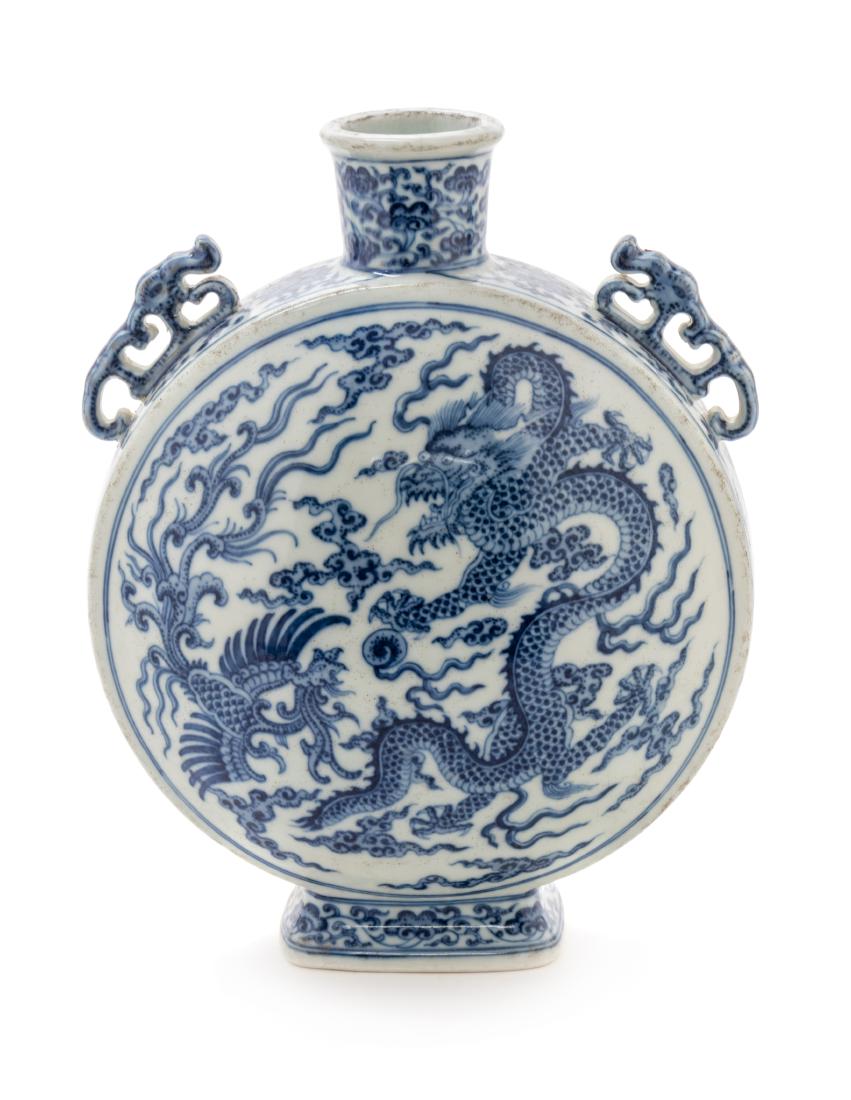 A Chinese Blue and White Porcelain Mook Flask Height 9: A Chinese Blue and White Porcelain Mook Flask 20th century painted with dragon decoration, the shoulders molded with a pair of dragon-form handles. Height 9 1/2 inches. Estimate $300-500