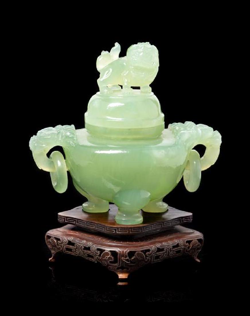 * A Chinese Serpentine Tripod Censer Height overall 6: * A Chinese Serpentine Tripod Censer 20th century the globular body raised on three cabriole legs, the shoulder sets with a pair of dragon head-form handles suspending loose rings, further raised on a