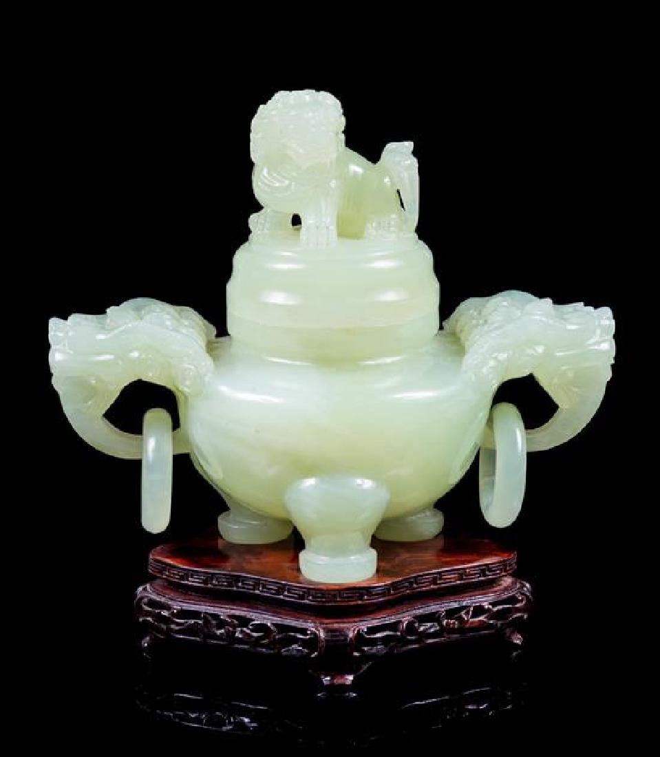 A Chinese Carved Serpentine Tripod Censer Height 6 1/4: A Chinese Carved Serpentine Tripod Censer 20th century raised on a fitted hardwood stand. Height 6 1/4 inches. Estimate $300-500