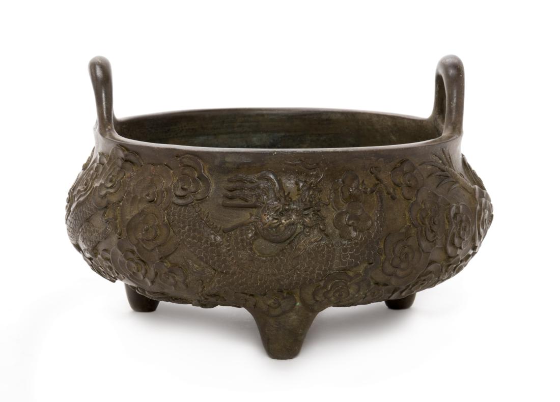 A Chinese Bronze 'Dragon' Tripod Censer Diameter 5 1/2: A Chinese Bronze 'Dragon' Tripod Censer 20th century the compressed body chased with dragon decoration, surmounted by a pair of upright handles, the underside bearing an apocryphal Xuande six-characte