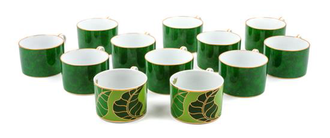 * An Assorted Group of Twelve Lynn Chase Porcelain: * An Assorted Group of Twelve Lynn Chase Porcelain Coffee Cups comprising 10 in the Imperial Malachite pattern, and 2 in the Gold Leaf pattern. Height: 2 1/4 inches (each). Estimate $50-70 Property fr