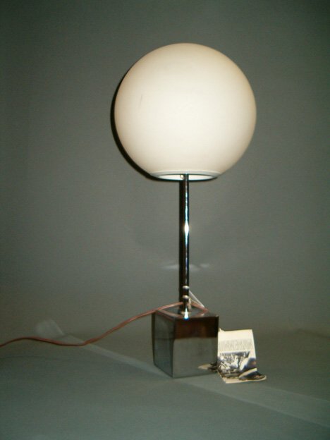 ROBERT SONNEMAN CHROME TABLE LAMP Ca. 1970 Circul: ROBERT SONNEMAN CHROME TABLE LAMP Ca. 1970 Circular frosted globe on cylindrical standard, cube-form base, labeled with promotional booklet. H: 21 in.