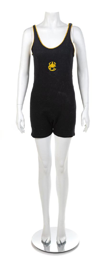 Women's Athletic Club Swimsuit, 1910-20s: Women's Athletic Club Swimsuit, 1910-20s Black wool knit swimsuit trimmed with yellow wool and closed with a single button on the left shoulder. The initials for the Women's Athlectic Club in black an