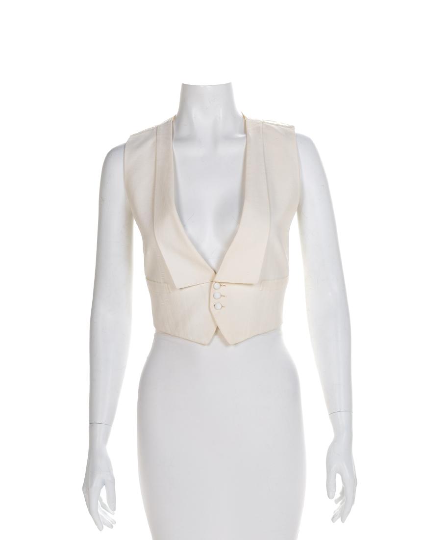 Men's White Cotton Vest, 1900-1920s: Men's White Cotton Vest, 1900-1920 White cotton pique vest with a deep v-neckline finished with a self-fabric lapel, hip pockets, center front button closure, an open back with only an adjustable belt