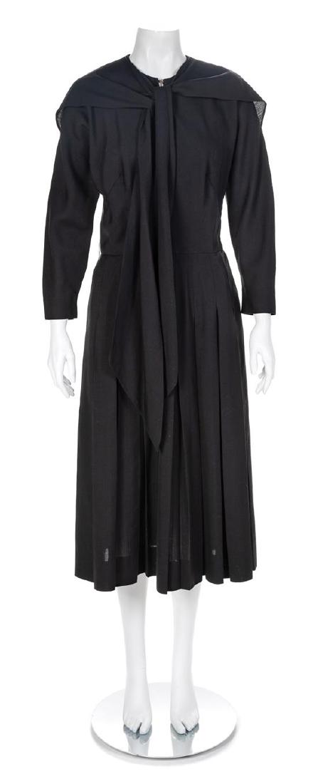 Claire McCardell Black Cotton Dress, 1950s No size: Claire McCardell Black Cotton Dress, 1950s Black cotton with bias-cut long-sleeve bodice with a round neckline and self-fabric ties extending from shoulder seam. The deep pleats in the skirt are sewn