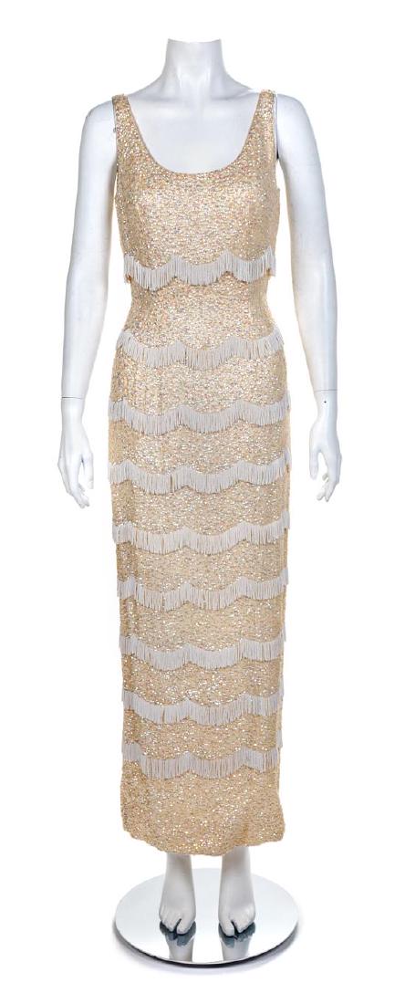 Ivory Beaded Fringe and Sequin Dress, 1960s: Ivory Beaded Fringe and Sequin Dress, 1960s Unlabeled Estimate $200-300 Stains on the inside. Black speckled stains on the back of the dress. The stated overall condition of the lot is based on the as