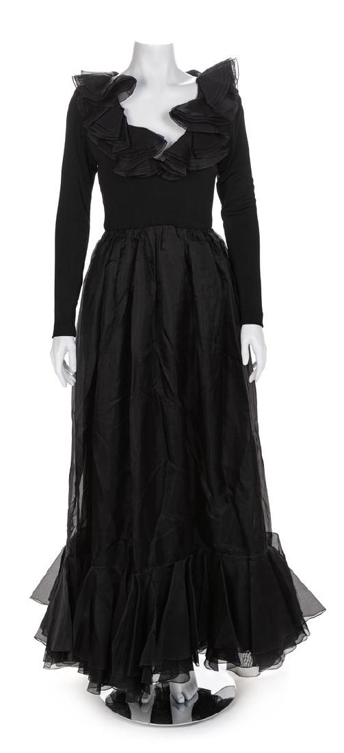A Bob Mackie and Ray Aghayan Black Gown, 1980-90s: A Bob Mackie and Ray Aghayan Black Gown with knit bodice and long sleeves. Full skirt gathered into the waistline and with multiple layers, including the peplum hem. The neckline is also trimmed with