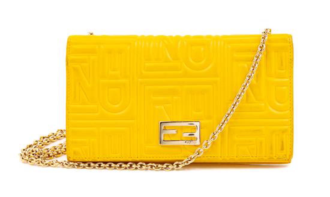 Fendi Embossed Leather Wallet/Shoulder Bag, 1990s: Fendi Yellow Monogram Embossed Leather Wallet/Shoulder Bag, 1990s With goldtone hardware, a removable goldtone chain shoulder strap, a front flap with a snap button closure an interior purple logo lin